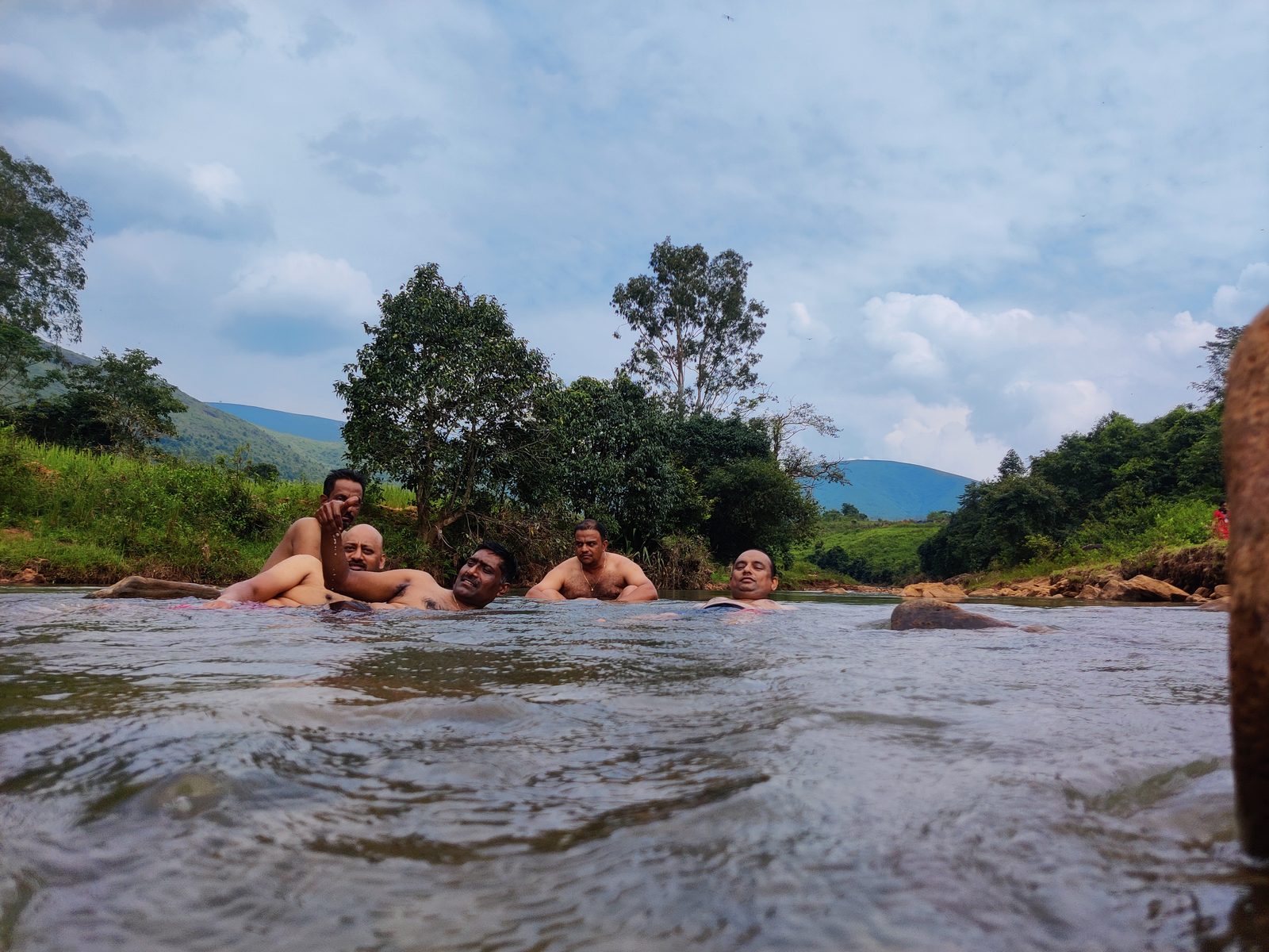 Cyclists relaxing in a stream after a ride