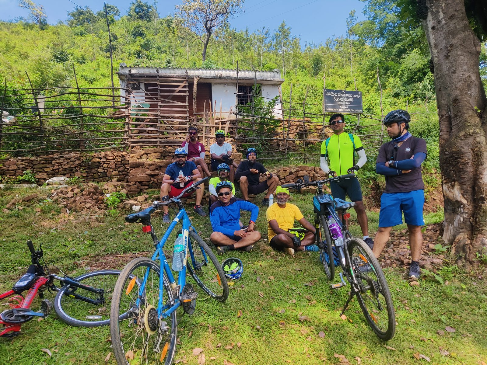Cyclists resting at a tribal hamlet